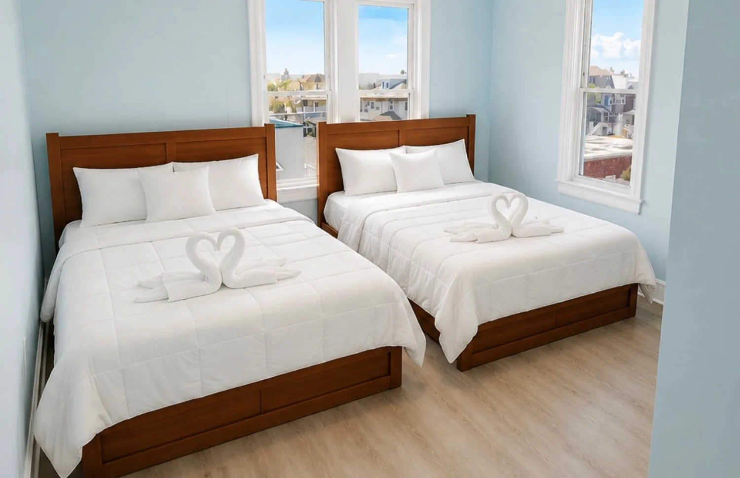 Classic hotel room with two full beds and white linens